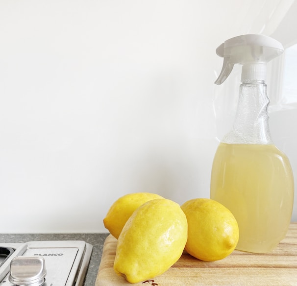 yellow lemon fruit beside clear glass bottle