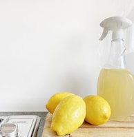 yellow lemon fruit beside clear glass bottle