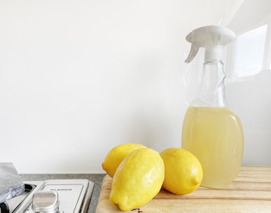 yellow lemon fruit beside clear glass bottle