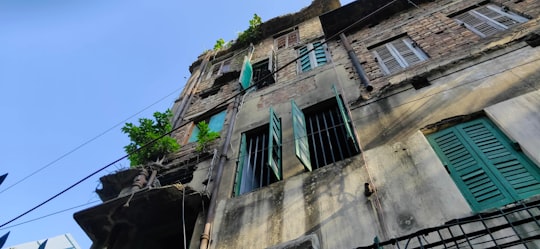 gray concrete building under blue sky during daytime in Kolkata India