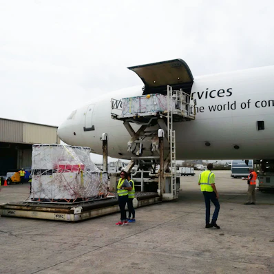 A busy customs clearance office with staff handling documents and packages.