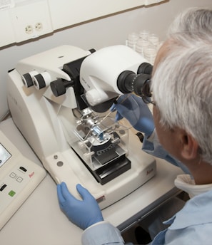 man in white shirt using white sewing machine