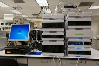 black flat screen computer monitor on white wooden desk