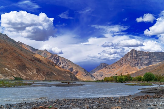 brown and green mountains under blue sky and white clouds during daytime in Spiti Valley India