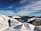 Traveler hiking along a scenic trail with snow-capped peaks in the background