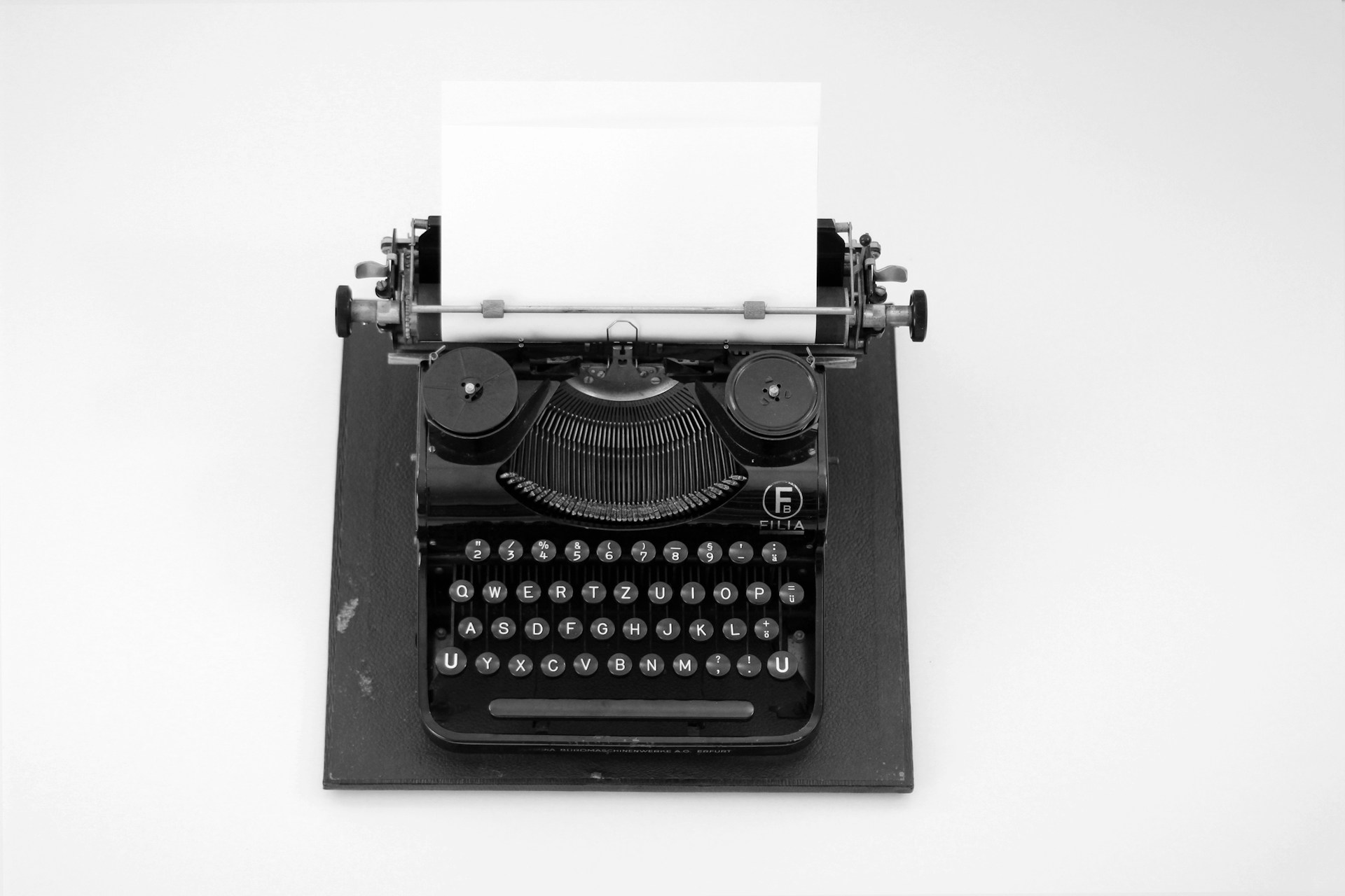black and white typewriter on white table