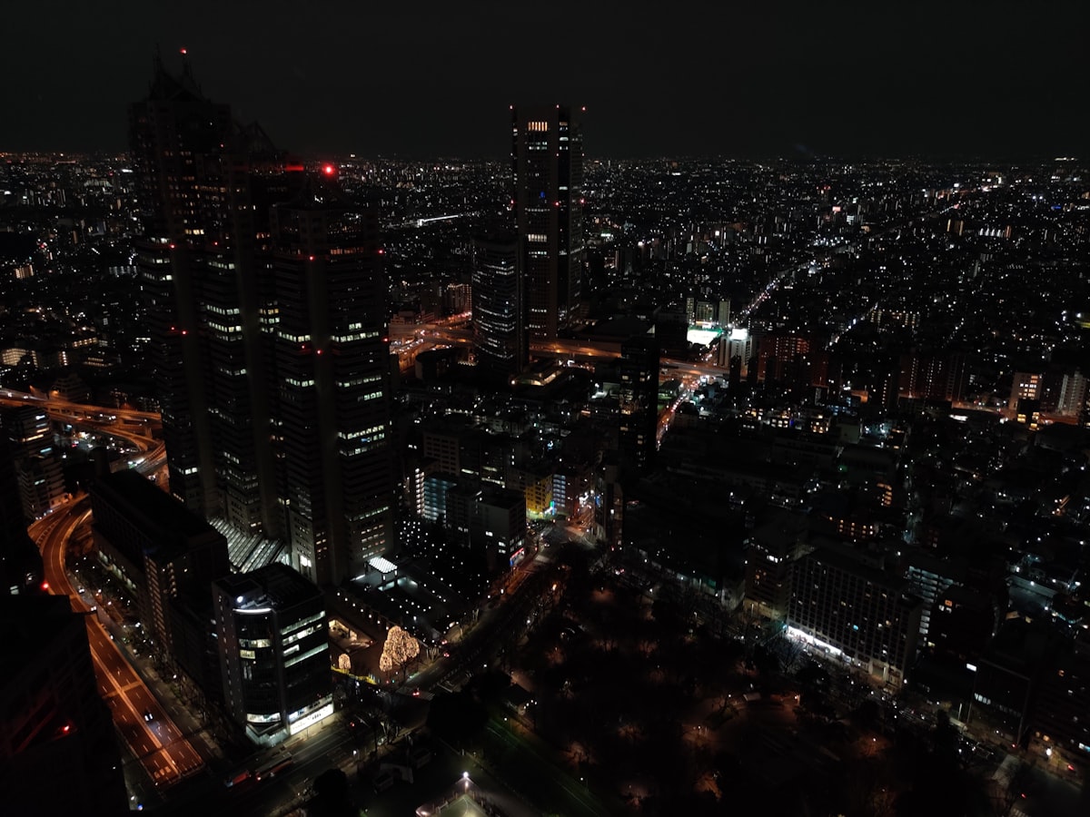 Tokyo city skyline at night with high-rise buildings illuminated