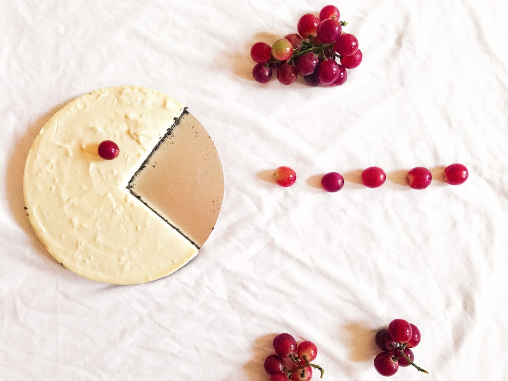 red and white round fruit on white textile