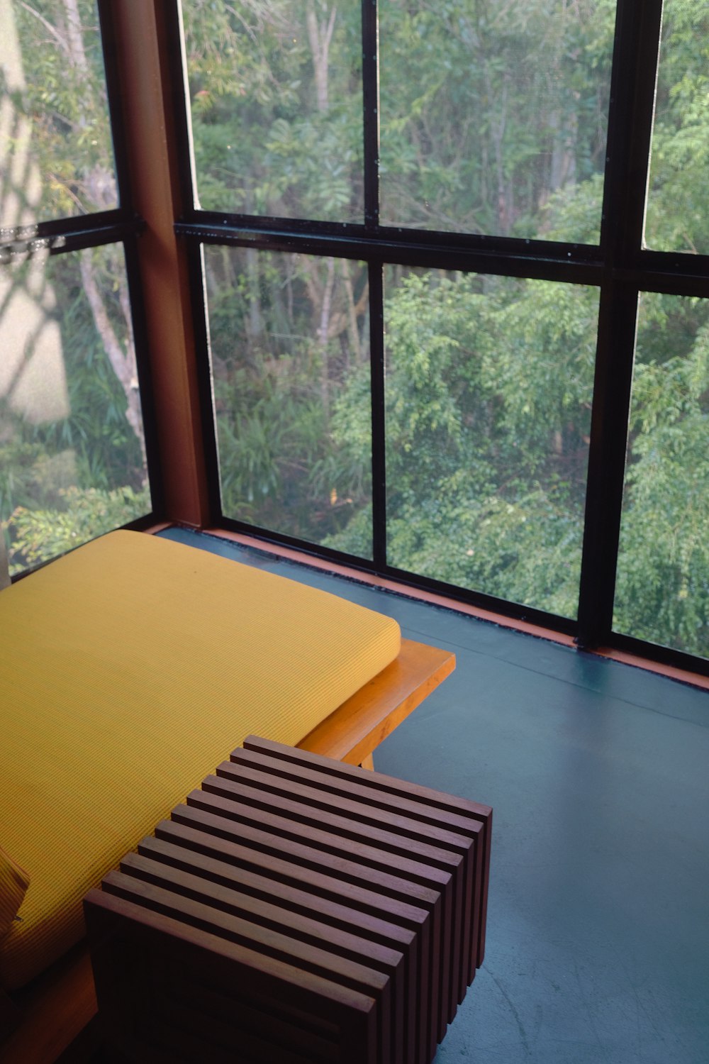 black wooden framed yellow padded chair