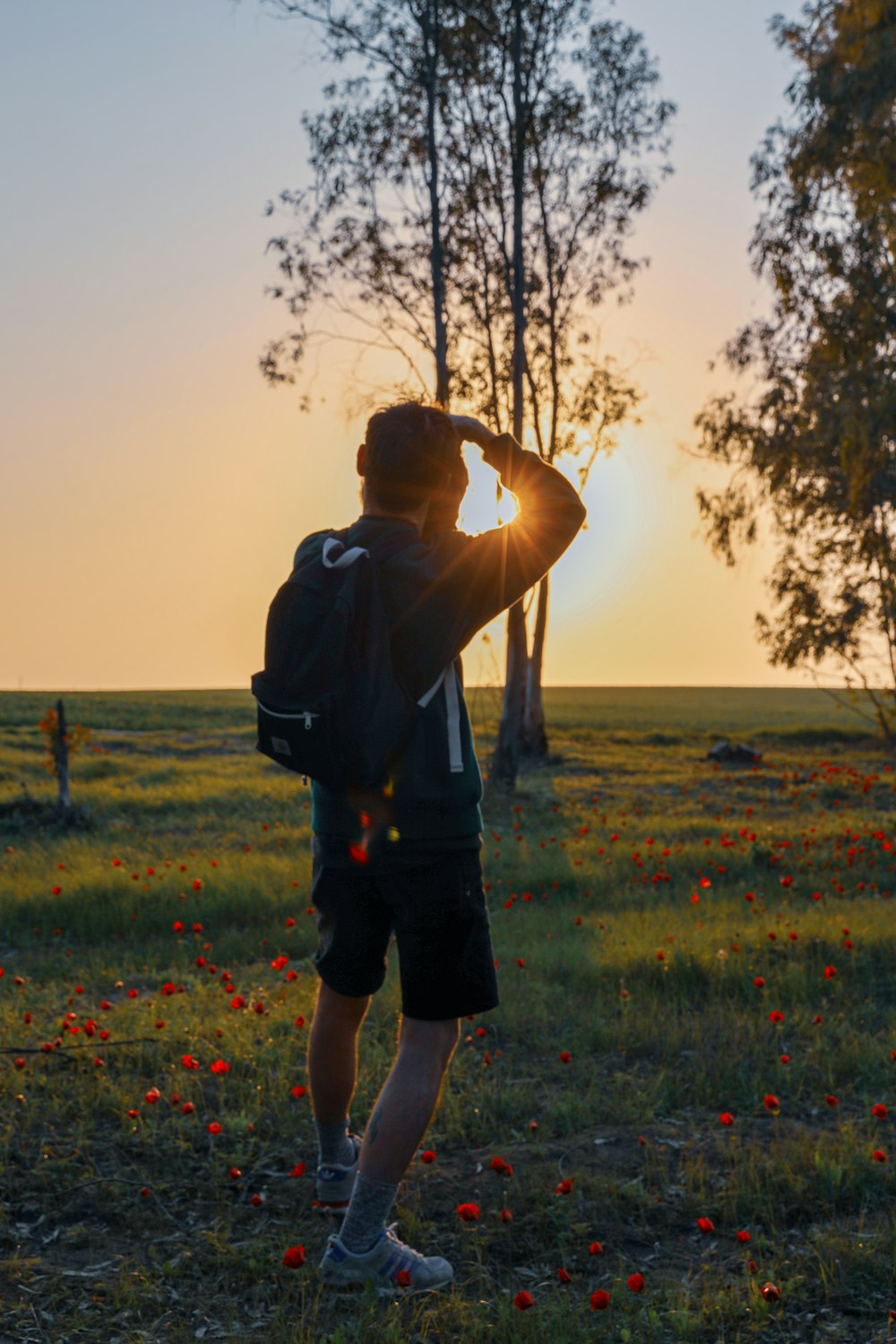 man in black t-shirt standing on green grass field during daytime