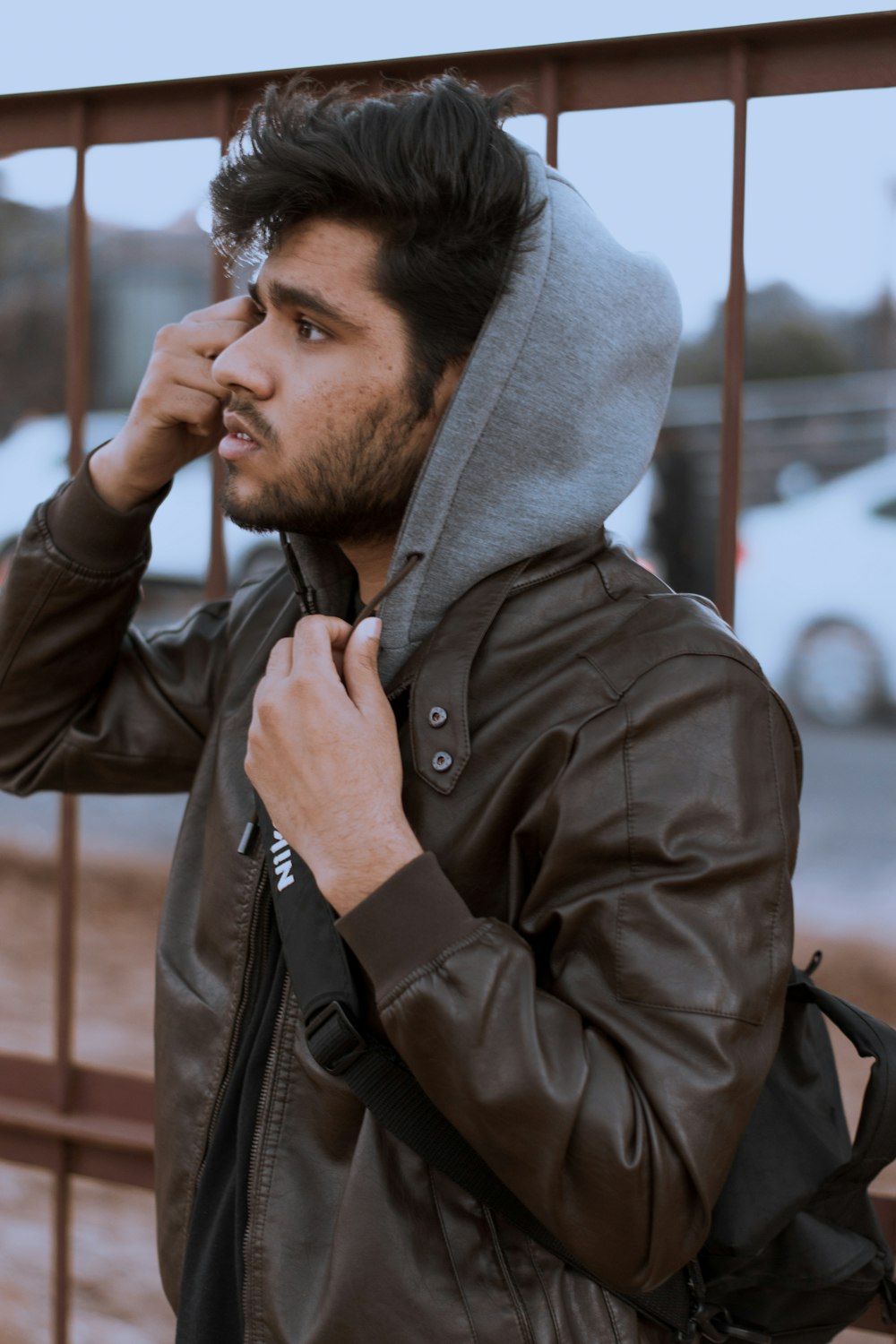 man in gray hoodie smoking cigarette