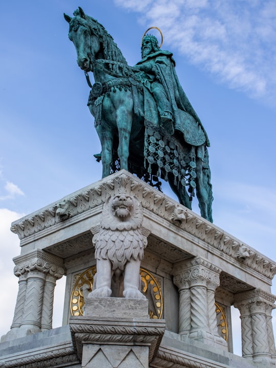 statue of man holding book in Fisherman's Bastion Hungary
