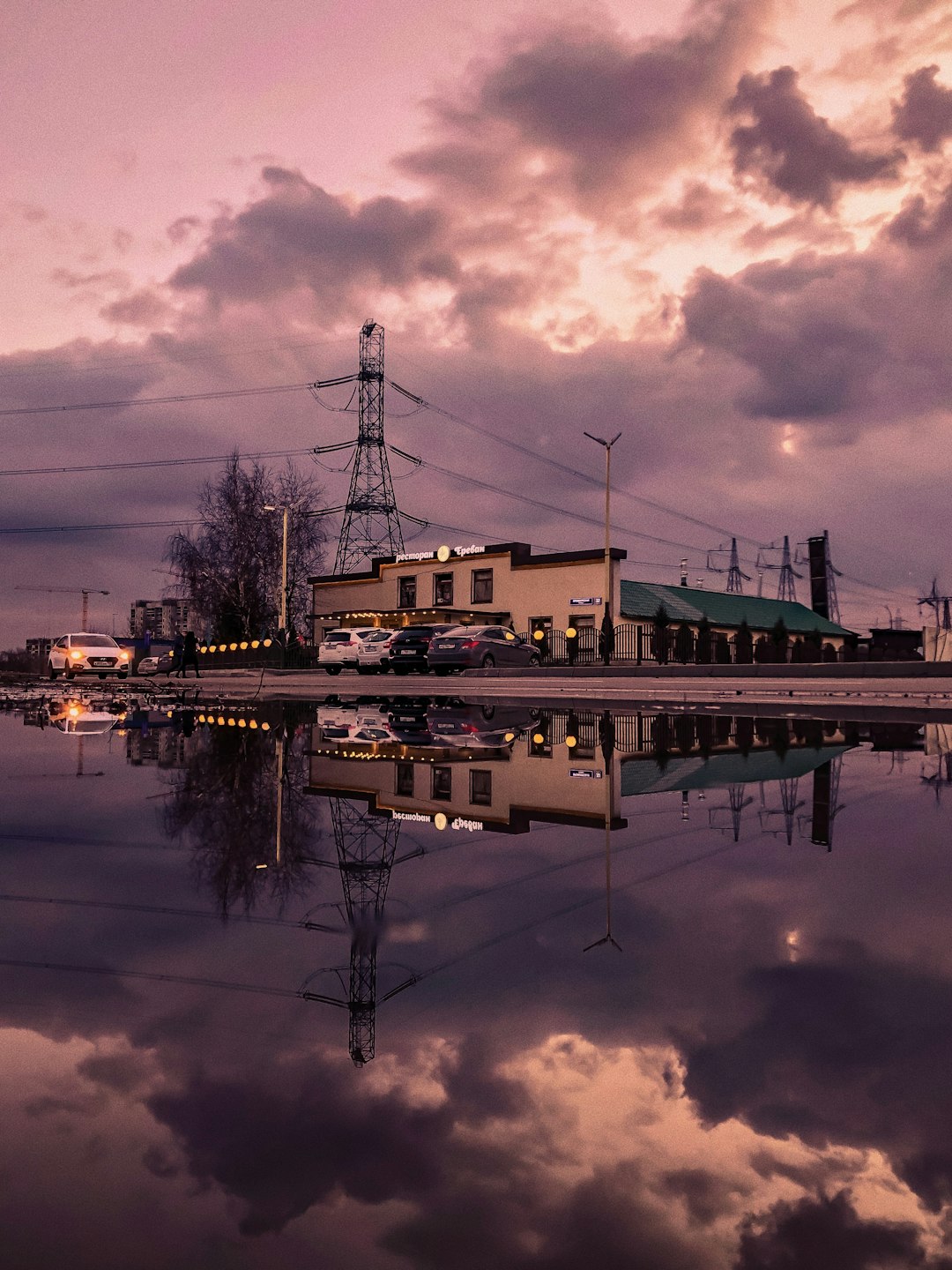 white and brown concrete building near body of water during night time