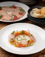 Close-up of a beautifully plated traditional Basque dish with vibrant colors.