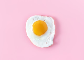 sunny side up egg on pink surface