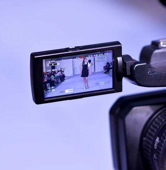 A sleek runway shot capturing a model in navy blue streetwear under soft spotlight.