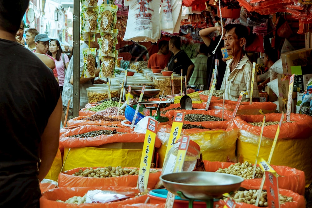 woman in brown coat standing in front of food stall