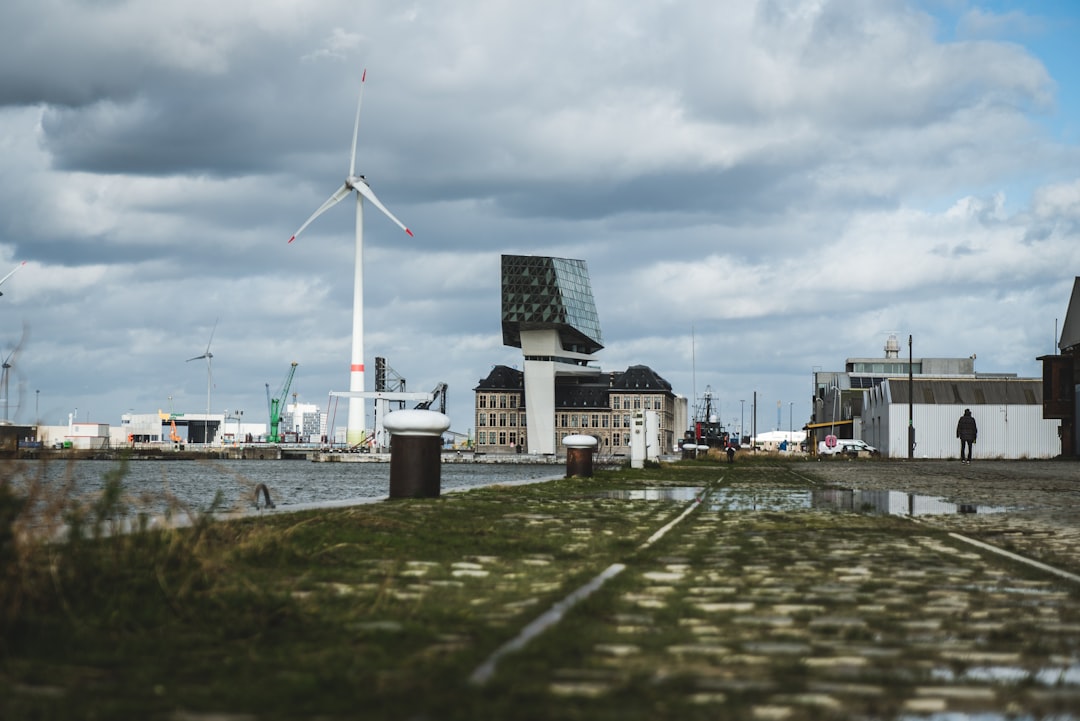 windmill near body of water during daytime