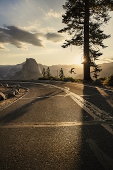 gray asphalt road near mountain during daytime