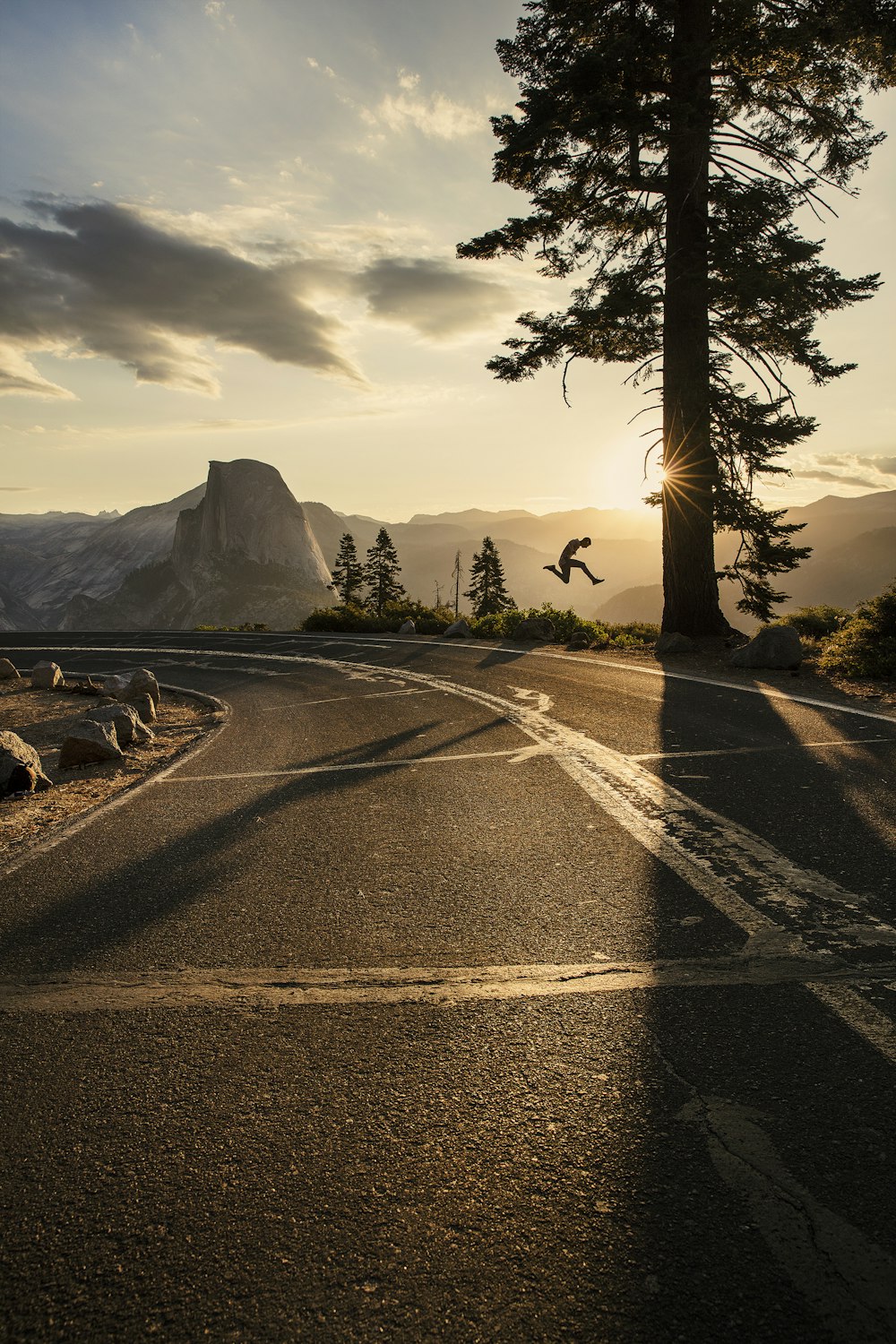 gray asphalt road near mountain during daytime