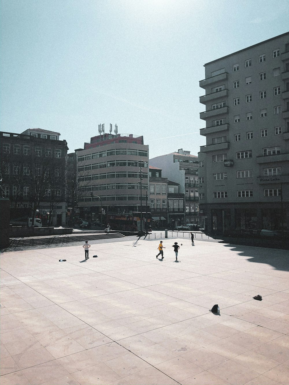 people walking on sidewalk near high rise buildings during daytime