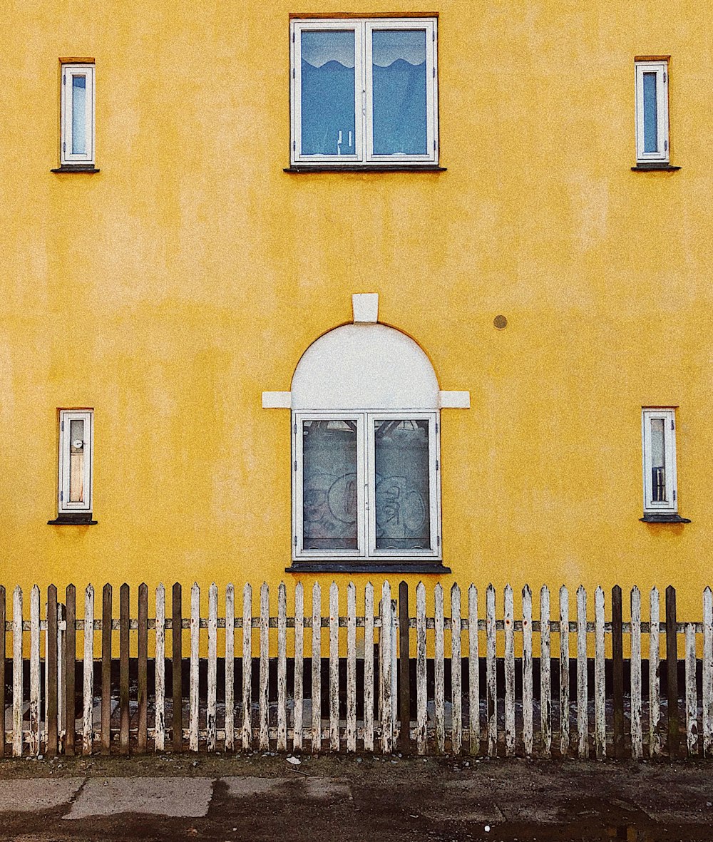 orange concrete building with white window frame