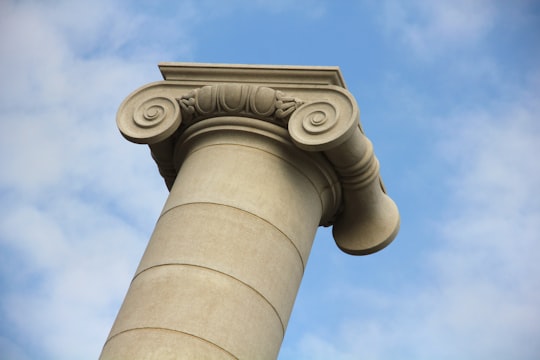 white concrete pillar under blue sky during daytime in Quatre Columnes Spain