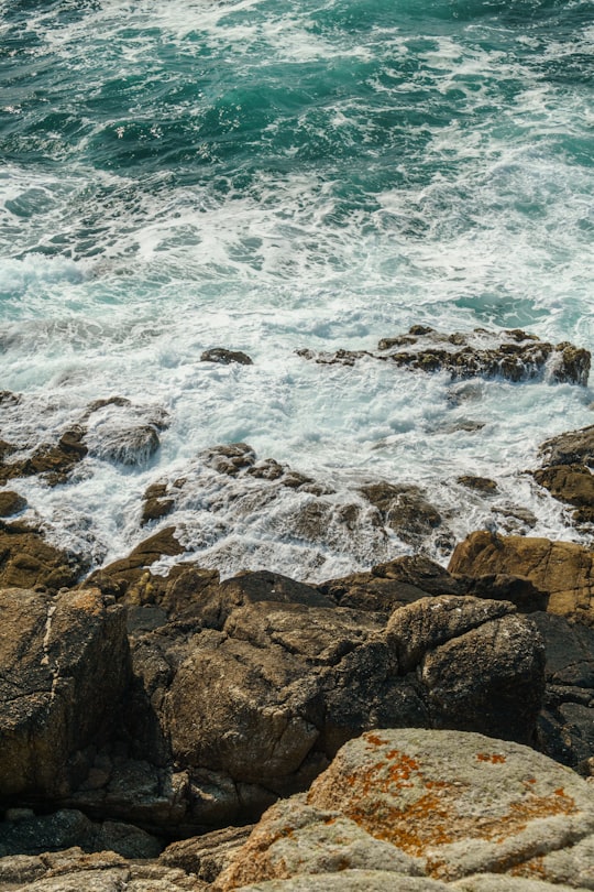 brown rocky shore with ocean waves during daytime in A Coruña Spain