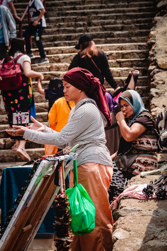 woman in black and white stripe shirt and pink and green hijab in Baguio City Philippines