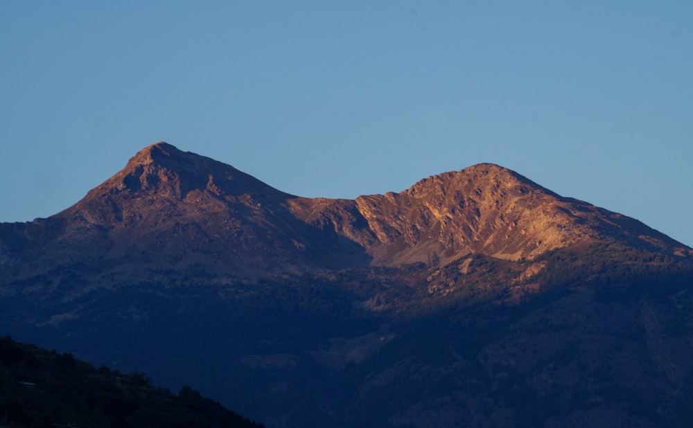 brown and green mountains under blue sky during daytime