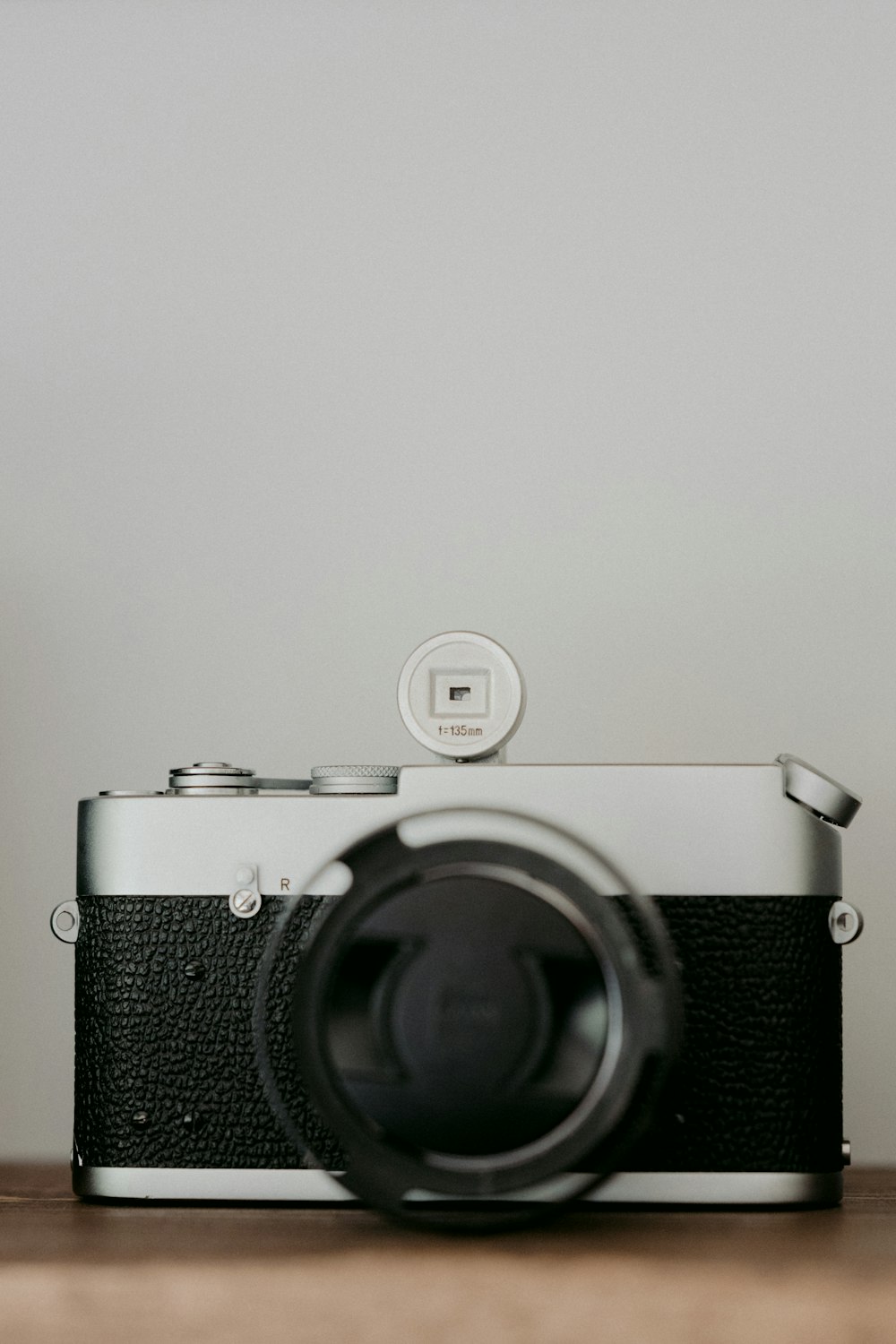 black and silver camera on white table