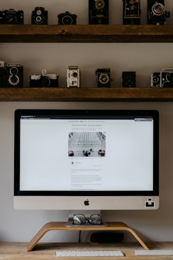 silver imac on brown wooden table