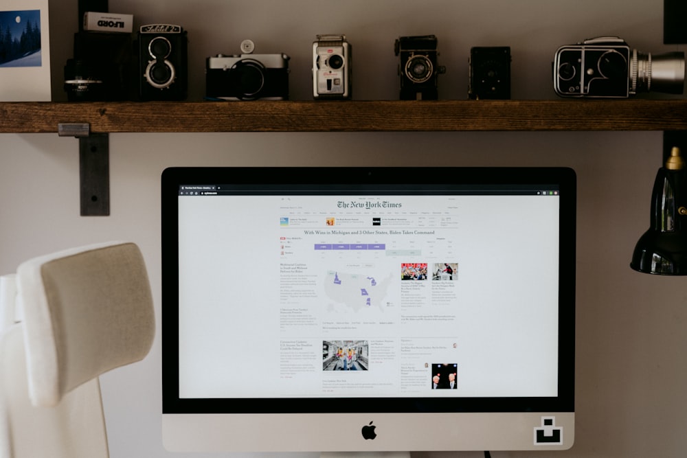 silver imac on brown wooden table