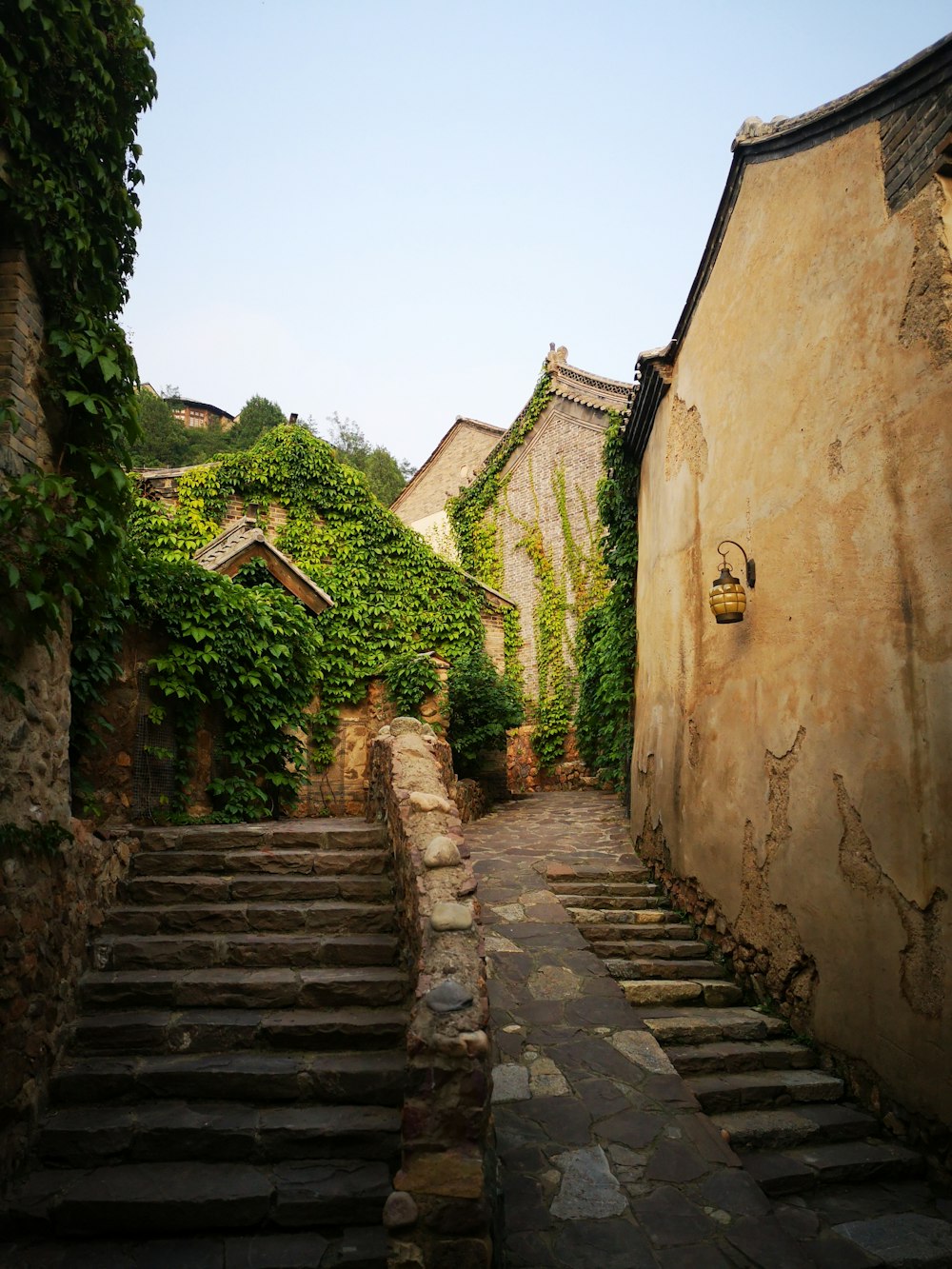 gray concrete stairs between brown concrete houses during daytime