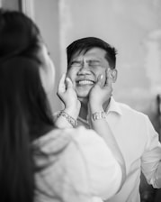 A candid photo capturing a playful and cheeky moment between friends.