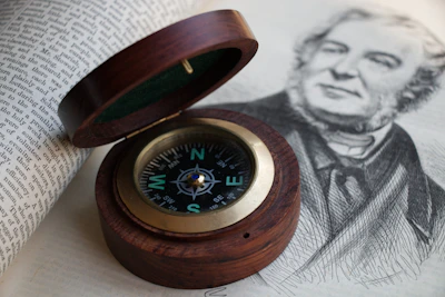 An elegant close-up of a compass and architectural sketch, symbolizing direction and structure.