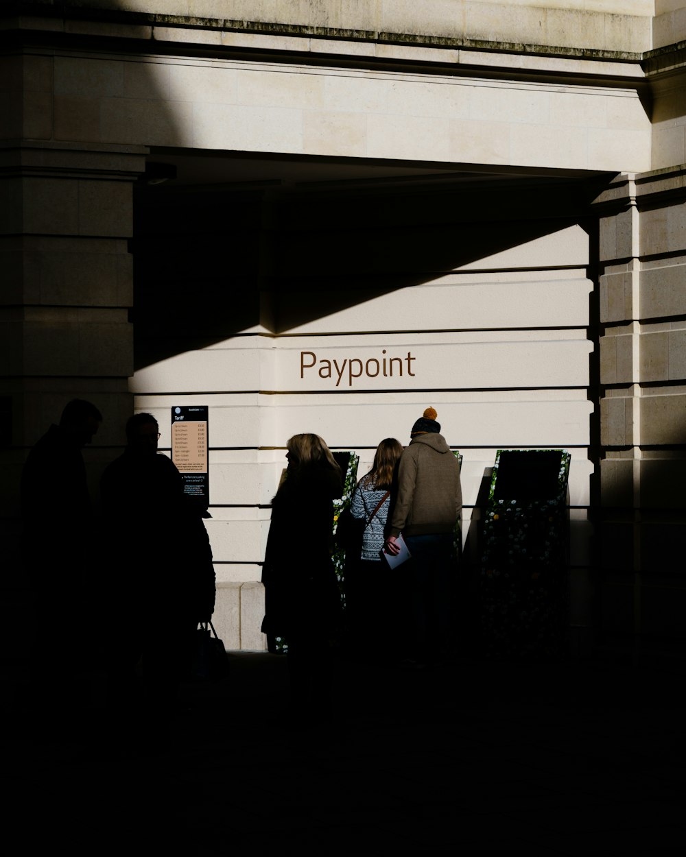 a group of people standing outside of a building