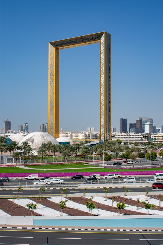cars parked on parking lot near high rise building during daytime in Dubai Frame United Arab Emirates