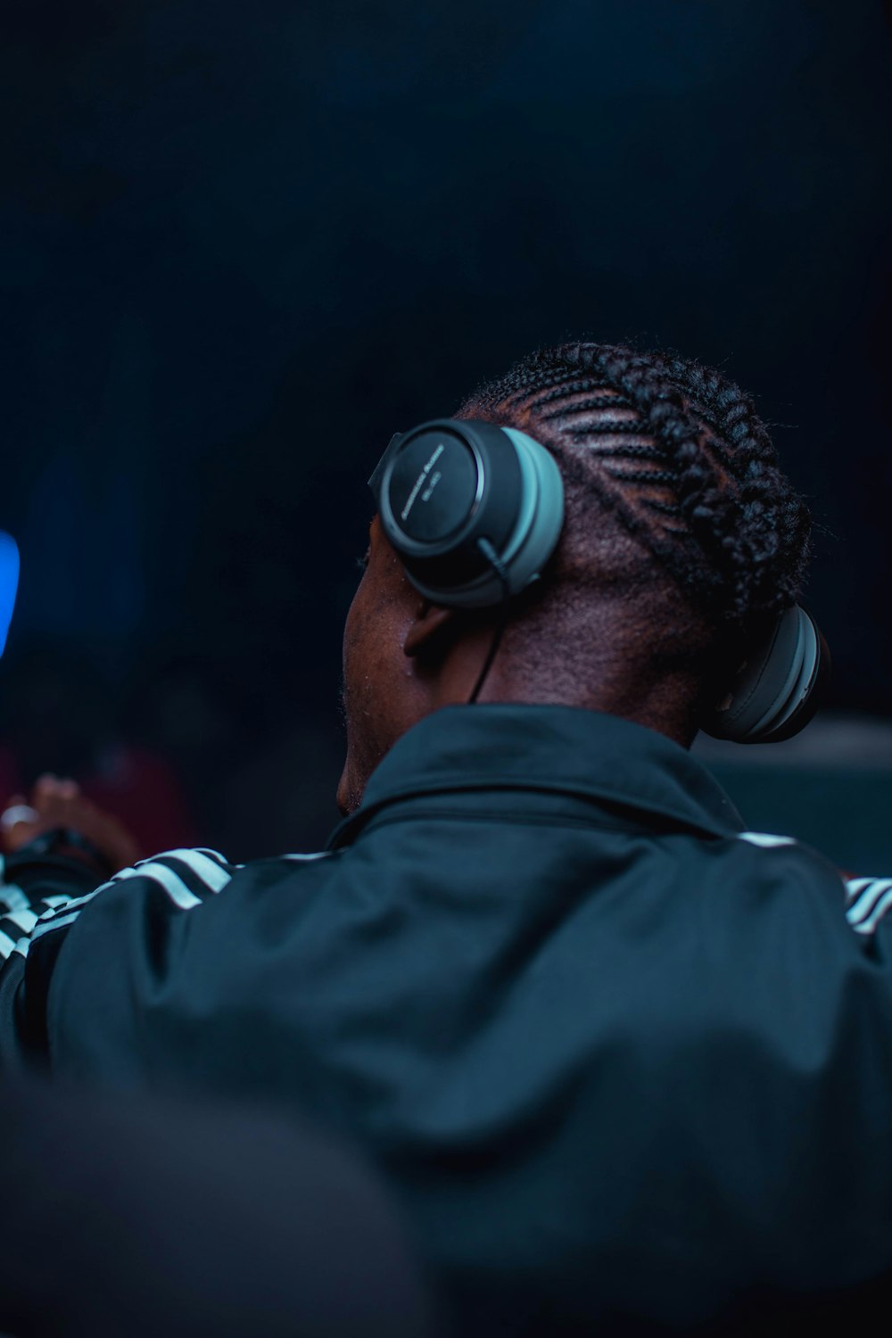 man in black jacket wearing black headphones