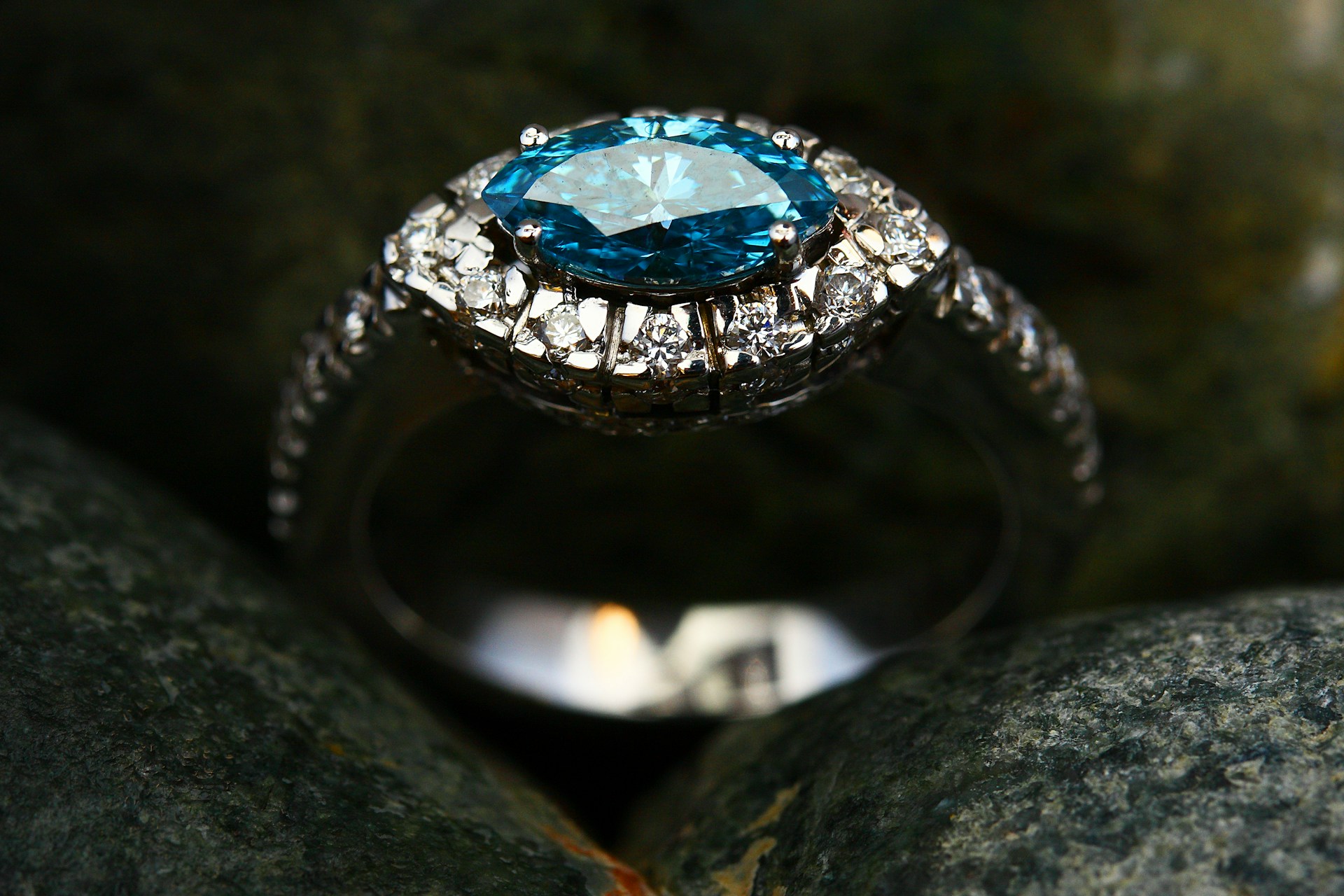 silver diamond ring on gray stone