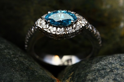 silver diamond ring on gray stone