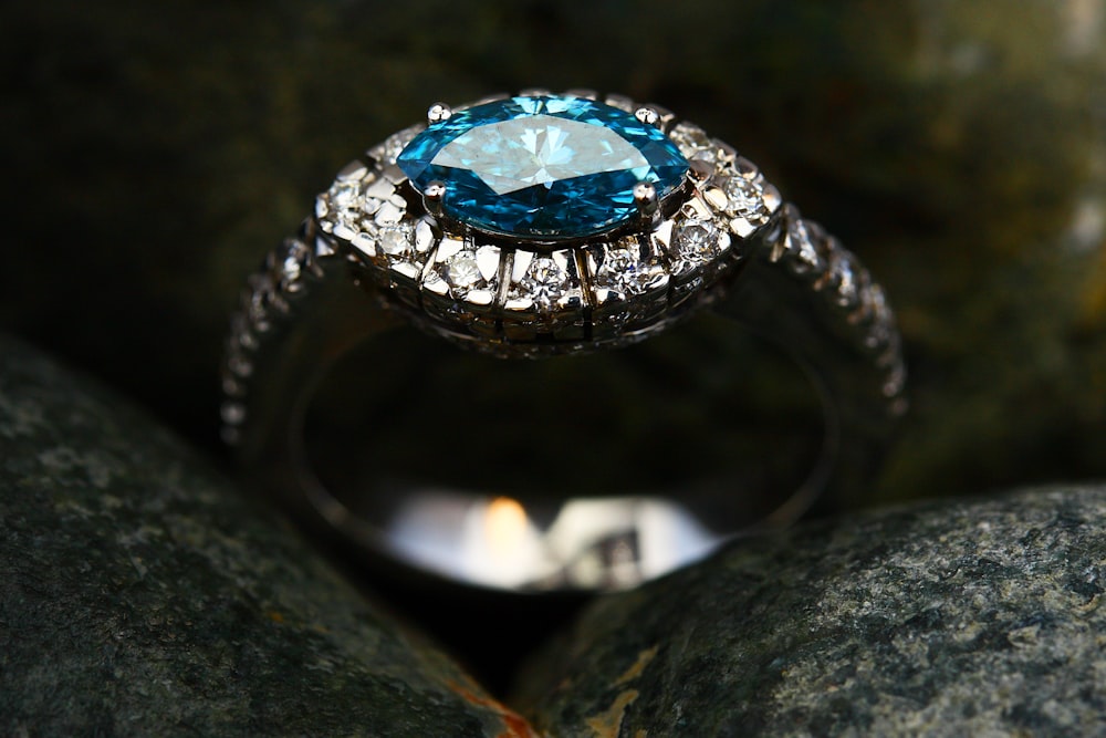 silver diamond ring on gray stone