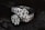 Two diamond rings featuring multiple small, clear diamonds arranged in a floral pattern set against a dark, contrasting background that enhances their sparkle.