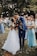 man in blue suit kissing woman in white wedding dress