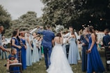 people in white dress dancing on green grass field during daytime