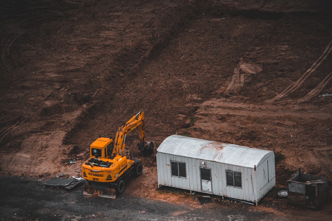 yellow and white truck on brown soil, Working Crane