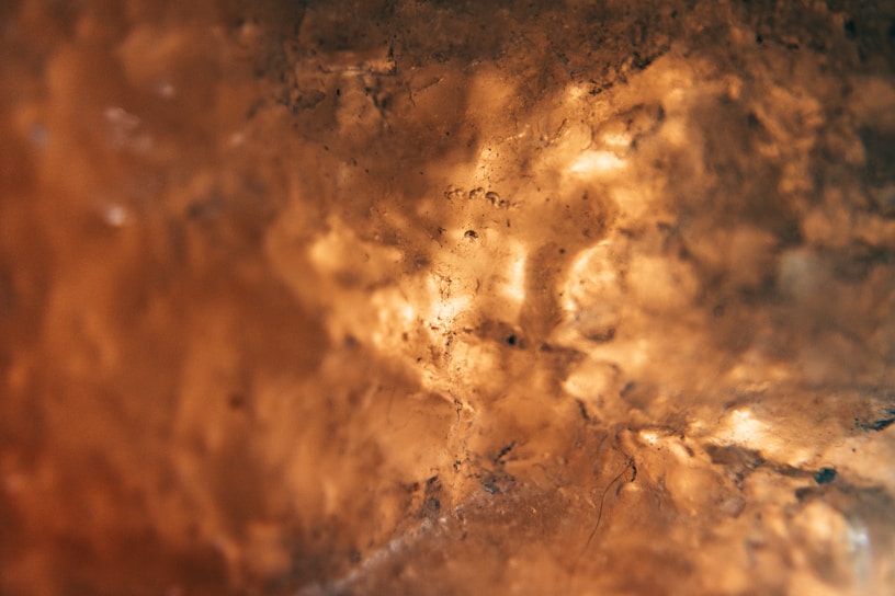 A softly lit close-up of a textured AI-generated wall art piece in warm sand tones.