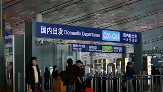 people standing in front of blue and white building during daytime