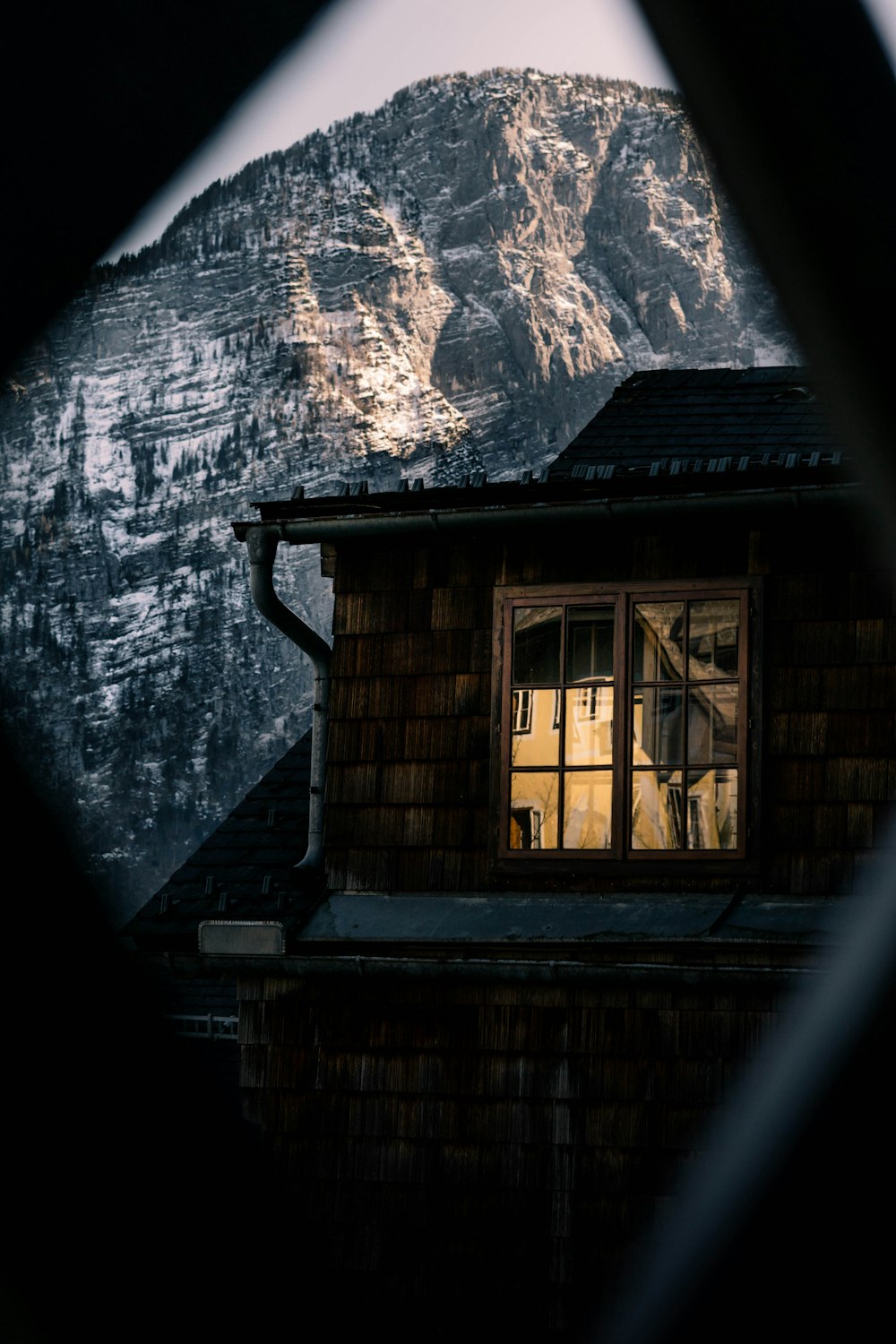 brown wooden door with snow covered mountain in the distance