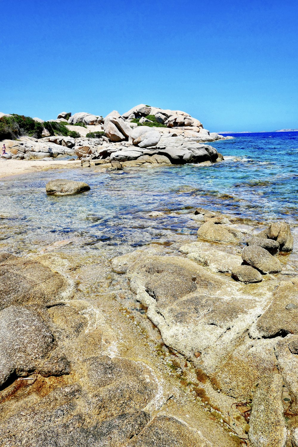 gray rocks on sea shore during daytime